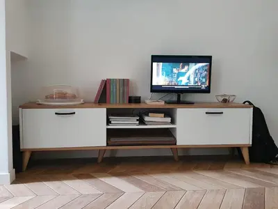 a television sitting on top of a white cabinet at Casa Mari - Cozy Apartment San Paolo Rome in Rome