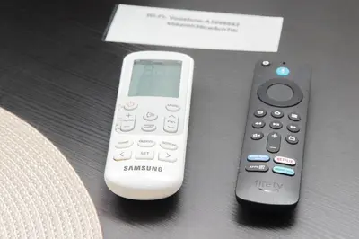 two remote controls sitting on top of a table at CasAchille Mini Studio in Rome