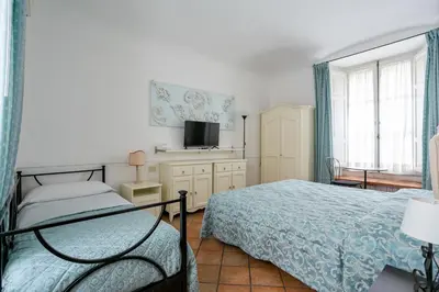 a bedroom with a bed and a tv and a window at Scipioni Suites in Rome