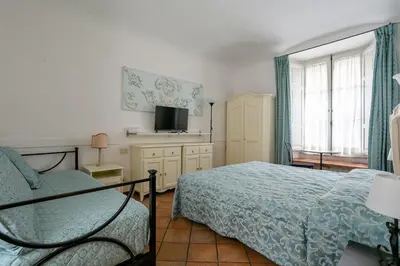 a bedroom with a bed and a television in it at Scipioni Suites in Rome