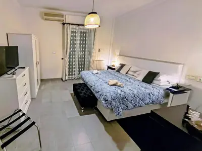 a bedroom with a bed with a blue comforter at Gianicolense Holiday Suite-Apartment in Rome