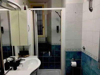 a bathroom with a sink and a shower at Apartment in historic palace in Rome