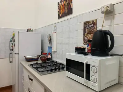 a kitchen with a stove and a refrigerator at Apartment in historic palace in Rome