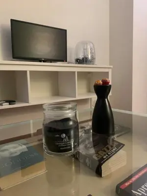 a glass table with a tv and a vase on it at Apartment in historic palace in Rome