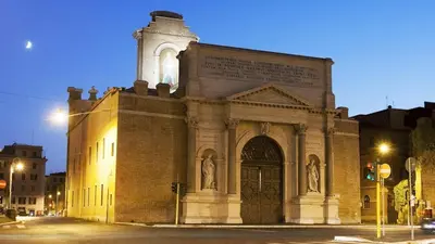 a large brick building with a clock tower on a street at Apartment in historic palace in Rome