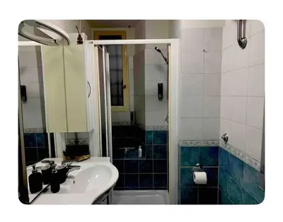 a bathroom with a sink and a shower and a tub at Apartment in historic palace in Rome