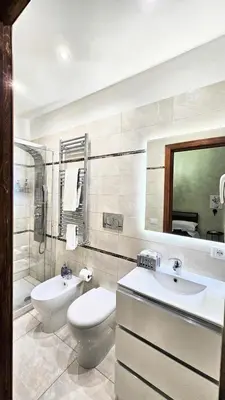 a bathroom with a toilet and a sink at Rome Boulevard Suite in Rome