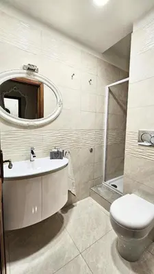 a bathroom with a sink and a toilet and a mirror at Rome Boulevard Suite in Rome