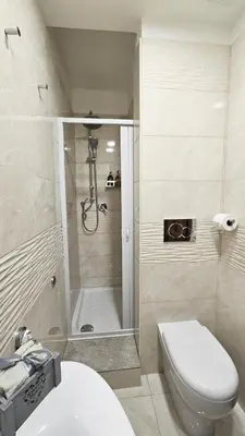 a bathroom with a shower and a toilet and a sink at Rome Boulevard Suite in Rome