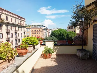 a balcony with potted plants on a building at Vatican Penthouse - Terrace with view in Rome