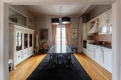 a kitchen with a table in the middle of a room at Vatican Penthouse - Terrace with view in Rome