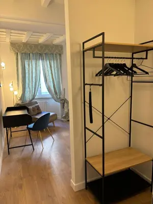 a room with a living room with a desk and a shelf at Paolina Place in Rome