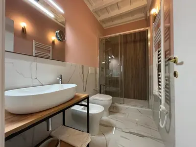a bathroom with a sink and a toilet and a shower at Paolina Place in Rome