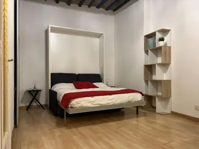 a bedroom with a bed with a red blanket at Loft Trastevere in Rome