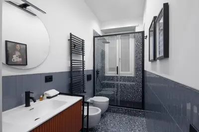 a bathroom with a toilet and a sink and a shower at Cereate Suites in Rome