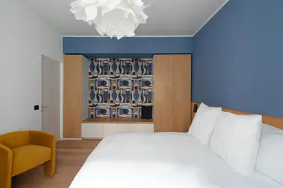 a bedroom with a white bed and a blue ceiling at Cereate Suites in Rome