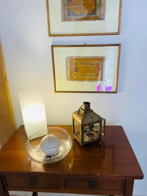 a table with a lamp and a lantern on it at Silent Oasis of Trastevere in Rome