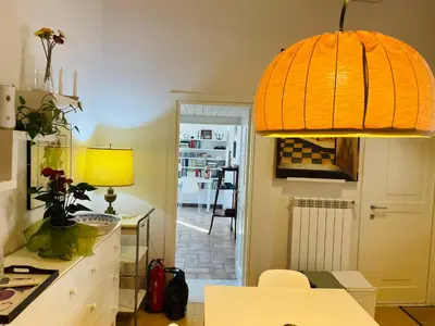 a kitchen with a table and a yellow lamp at Silent Oasis of Trastevere in Rome