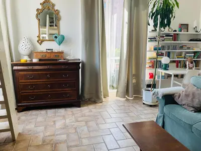 a living room with a blue couch and a dresser at Silent Oasis of Trastevere in Rome