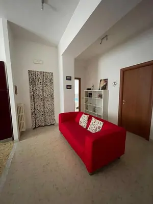 a red couch sitting in a living room at Metronio Relax in Rome