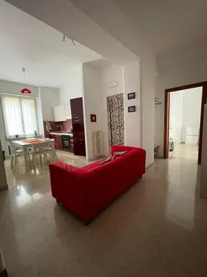a red couch in the middle of a living room at Metronio Relax in Rome