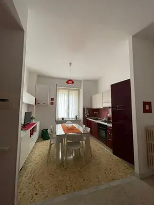 a kitchen with a table with chairs and a window at Metronio Relax in Rome