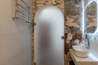a bathroom with a white sink and a mirror at Alma at Colosseum Luxury Apartment with View in Rome