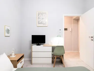a bedroom with a desk and a tv on a dresser at Rome Vatican Stay - Appartamento 2 camere da letto vicino al Vaticano in Rome