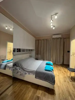 a bedroom with a large bed with blue towels on it at Nicoletti in Rome