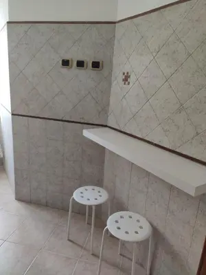 two stools sitting next to a counter in a room at Mary Apartment in Rome