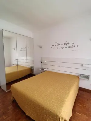 a bedroom with a bed and a mirror at Mary Apartment in Rome