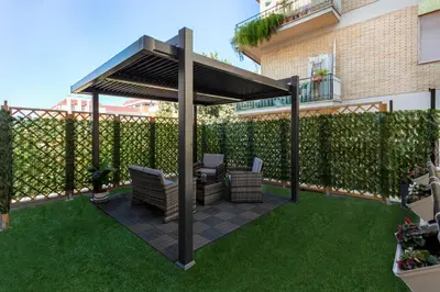 a gazebo with chairs and a table on a lawn at Hotelleria Prestige in Rome