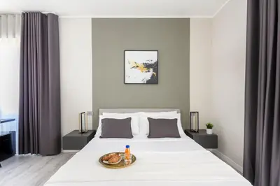 a bedroom with a bed with a tray of food on it at Hotelleria Prestige in Rome