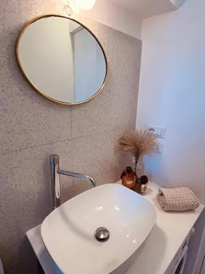 a bathroom with a white sink and a mirror at Clarus apartment in Rome in Rome