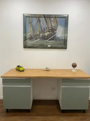 a desk with a painting of a ship on the wall at Domus Quadraro II in Rome