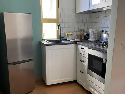 a kitchen with a refrigerator and a sink at Bed Bike Breakfast Appartamento Piramide in Rome