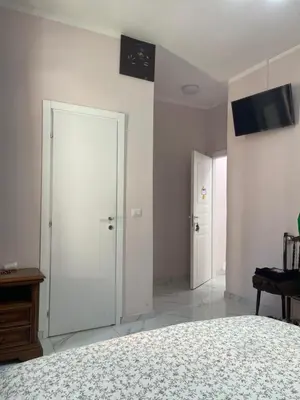 a bedroom with a bed and two white doors at Ines Stay in Rome