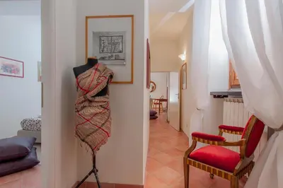 a room with a hallway with two chairs and a blanket at La Maison de Kappa in Rome