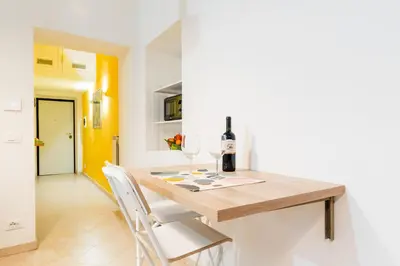 a kitchen with a wooden table with two glasses of wine at Apartment Maria in Monti in Rome