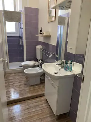 a bathroom with a toilet and a sink and a mirror at Apartment in Testaccio in Rome