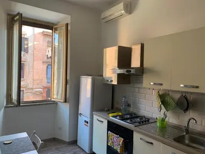 a kitchen with a white refrigerator and a sink at Apartment in Testaccio in Rome