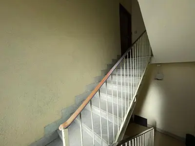 a staircase in a building with a metal railing at Mazzoni Suite, Panoramic Terrace and Comfort in Rome