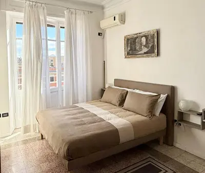 a bedroom with a bed in a room with a window at Piramide Cestia Apartment in Rome