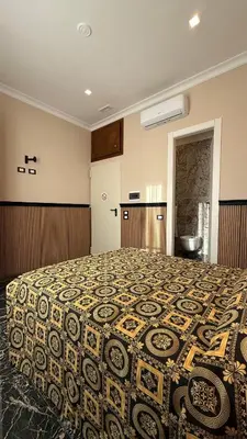 a bedroom with a large bed with a patterned blanket at Bed and Breakfast Eritrea in Rome