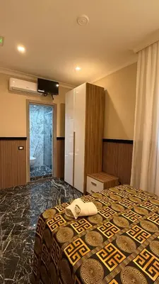 a hotel room with a bed with a television on the wall at Bed and Breakfast Eritrea in Rome