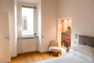 a bedroom with a bed and a window and a picture at Amor Guest House San Giovanni in Rome