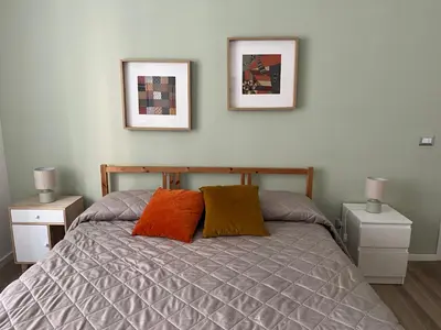 two framed pictures on the wall above a bed at Casa Giovi in Rome