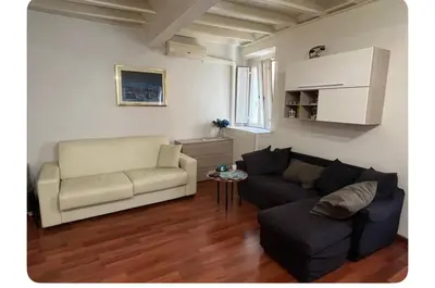 a living room with a couch and a chair at Casa in centro storico Largo Argentina in Rome