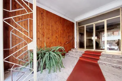 a room with a red carpet and a wooden wall at Graceful Apartment near St Peter METRO 100 mt in Rome