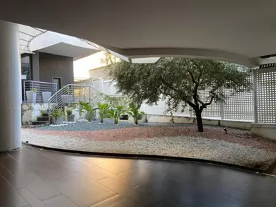 a courtyard with a tree in a building at P&P Luxury Home in Rome